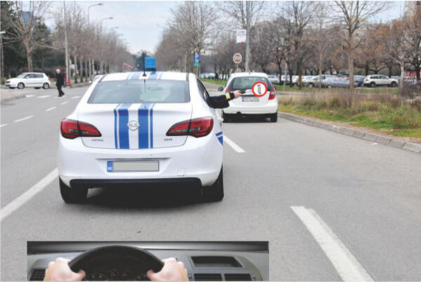 Slika uz pitanje: Znak koji daje ovlašćeni policijski službenik: