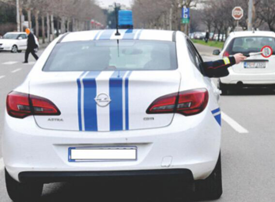 Slika uz pitanje: U situaciji prikazanoj na slici, znak koji daje policijski službenik vozaču znači: